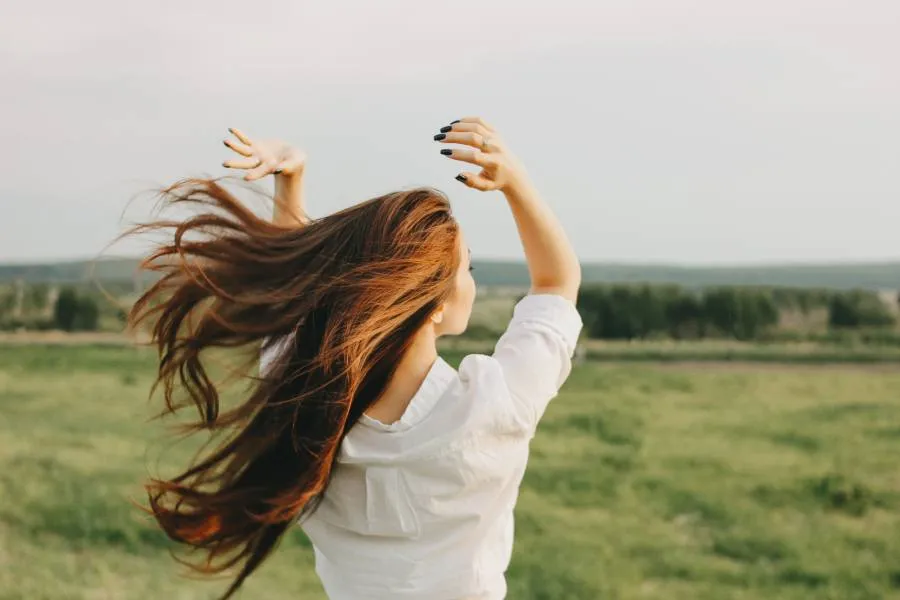 woman with long hair at a field